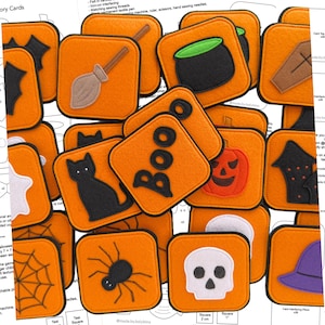 Könnte beinhalten: Eine Sammlung orangefarbener Halloween-Memory-Karten aus Filz mit verschiedenen schwarz-weißen Designs, darunter eine schwarze Katze, eine Spinne, ein Kürbis und ein Totenkopf. Das Wort "BOO" ist auf einer Karte zu sehen. Die Karten sind quadratisch und messen ca. 5 cm.