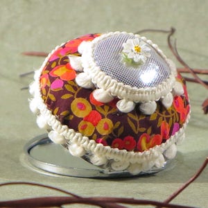 Pocket mirror with fabric shades pink and lame silver. Cream lace and flower.
