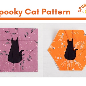 May include: Two fabric patchwork blocks featuring a black cat silhouette. The first block is pink with a white bat and star pattern. The second block is orange with a white skeleton pattern. The blocks are labeled "Spooky Cat Pattern".