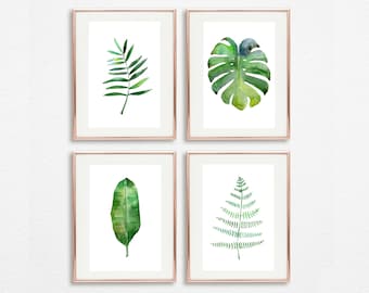 May include: Set of four framed watercolor prints featuring different types of green leaves. The prints are in simple white frames with a thin gold border.