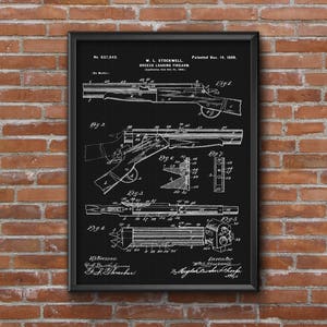 May include: Framed black and white patent illustration of a breech loading firearm, dated November 14, 1899. The detailed diagram shows various components and views of the firearm, including the breech mechanism and internal parts. The frame is black.