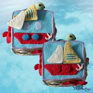 May include: Two crocheted blocks with a nautical theme. Each block features a sailboat with a red, white and yellow sail, a green turtle, and a blue and red boat. The blocks are made with a variety of colours, including blue, red, white, yellow and green.