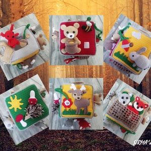 May include: Six colourful crocheted baby activity cubes with different animal and nature themes. Each cube features a variety of textures and elements for sensory exploration. The cubes are perfect for stimulating a baby's senses and promoting fine motor skills.