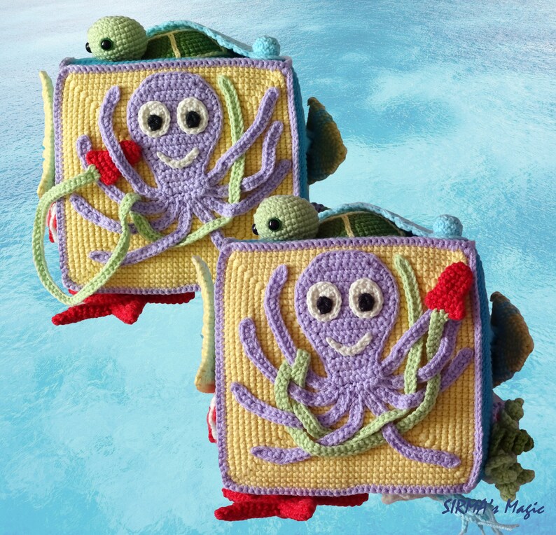 May include: Two crocheted square blocks featuring a purple octopus, green seaweed, and a red flower on a yellow background. Each block has a green turtle peeking out from behind it.