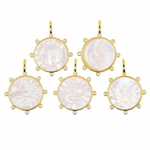 May include: Five gold pendants with white mother of pearl inlays. Each pendant features a different design: sun, moon, eye, snake, and butterfly. Each pendant is surrounded by a circle of small diamonds.