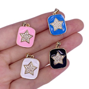 May include: Four enamel and gold-tone pendants with a star design. The pendants are in blue, pink, white, and black.