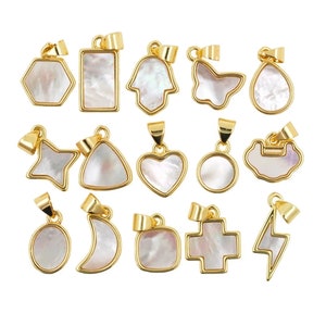 May include: A set of 15 gold-toned pendants with white mother-of-pearl inlays. The pendants are in various shapes, including a star, heart, circle, crescent moon, and more.