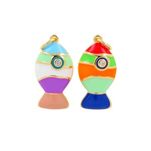 May include: Two colorful fish-shaped charms with gold-tone metal accents. One charm features a red, orange, green, and blue color scheme, while the other has a blue, green, white, and purple design. Each charm has a small, round, clear gem in the center.