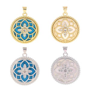May include: Four circular pendants featuring a central floral motif inlaid with clear crystals. Two pendants are gold-toned with turquoise or white stone backgrounds, and two are silver-toned with turquoise or white stone backgrounds.