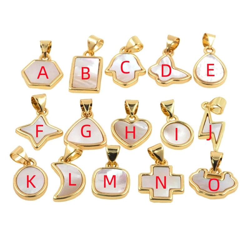 May include: A set of 15 gold-toned pendants with white mother-of-pearl inlays. Each pendant is shaped differently and features a letter from A to O.