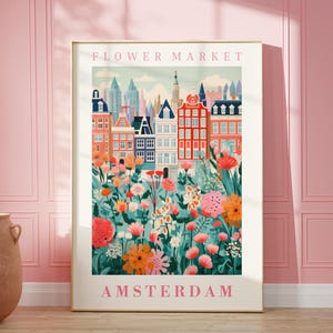 May include: A colorful illustration of a flower market in Amsterdam. The image features a cityscape with buildings and a vibrant floral display in the foreground. The text "FLOWER MARKET" and "AMSTERDAM" are displayed in pink.