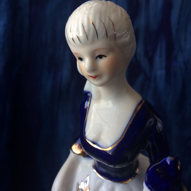 long dress KPM or KPM reproduction porcelain figurine of lady with bird cobalt blue and gold Victorian pink roses Rococo long skirt