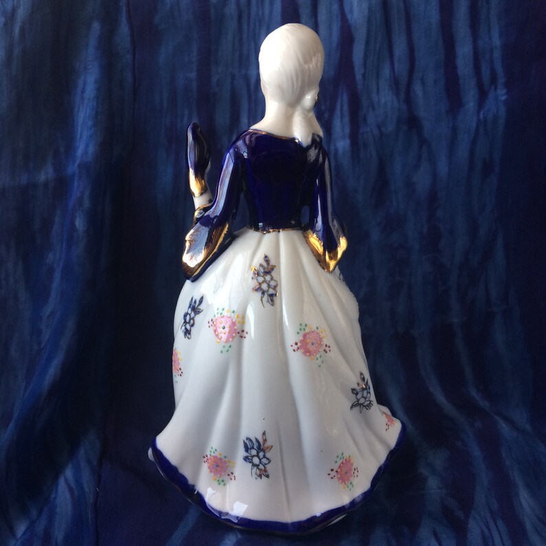 long dress KPM or KPM reproduction porcelain figurine of lady with bird cobalt blue and gold Victorian pink roses Rococo long skirt