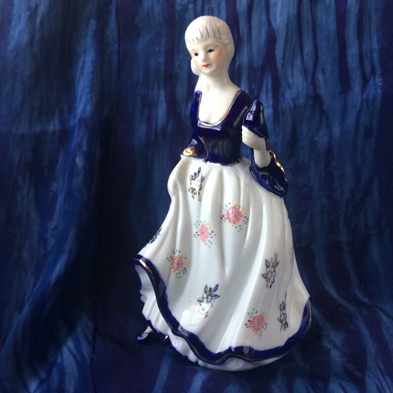 long dress KPM or KPM reproduction porcelain figurine of lady with bird cobalt blue and gold Victorian pink roses Rococo long skirt