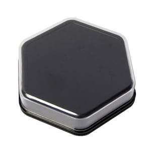 May include: A black hexagonal ink pad with a clear plastic cover.
