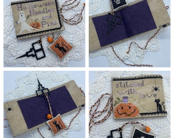 May include: A Halloween-themed needle minder with a ghost, pumpkin, and the text "Halloween Needles and Pins". The needle minder is attached to a small black cat pincushion. The needle minder and pincushion are on a white crocheted doily.