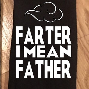 May include: Black sock with the text "FARTER I MEAN FATHER" in white block letters. Above the text is a white cloud-like design. The sock is laying on a wooden surface.