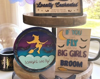 May include: A set of five Halloween-themed wooden signs with a witch, broom, and bats. The signs feature the text "Witches Market", "Locally Enchanted", "Tonight We Fly", and "If You Can't Fly With The Big Girls Stay Off The Broom".