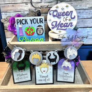 May include: A set of five wooden signs featuring Disney Villains. The signs are decorated with images of Maleficent, the Evil Queen, Ursula, and Cruella de Vil. The signs are painted in black, white, and purple. The text on the signs reads "Mistress of all Evil", "Fairest one of all", "Poor Unfortunate Soul", and "Queen of Mean".
