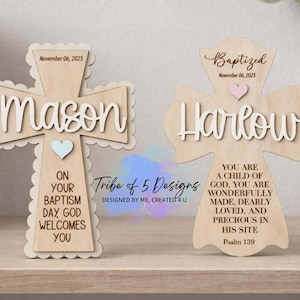 May include: Two wooden crosses with names and dates. One cross says "Mason" with a blue heart and the text "On your baptism day, God welcomes you." The other says "Harlow" with a pink heart and a bible verse.