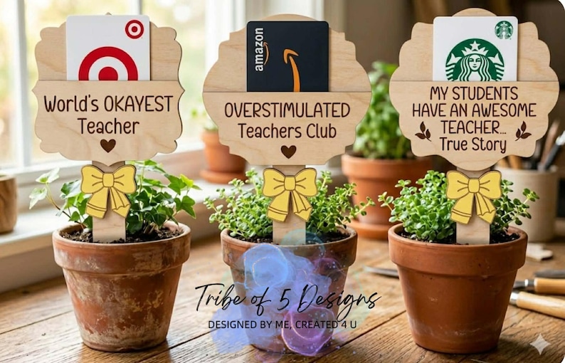 Puede incluir: Tres peque&ntilde;as plantas en macetas con letreros de madera. Los letreros dicen "World's OKAYEST Teacher", "OVERSTIMULATED Teachers Club" y "MY STUDENTS HAVE AN AWESOME TEACHER... True Story". Cada letrero contiene una tarjeta de regalo.