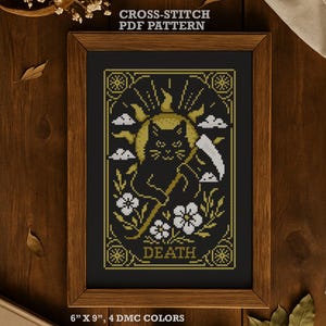 May include: A framed cross-stitch PDF pattern. The design features a black cat with a scythe, the word "DEATH", white clouds, flowers, and a golden sun. The frame measures 15 x 23 cm and uses 4 DMC colours.