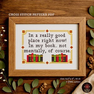 May include: A cross stitch pattern PDF featuring the text In a really good place right now! In my book.. not mentally, of course. The design includes two stacks of books in red, green, and black, framed by a yellow border, measuring 8.5 by 6 inches.