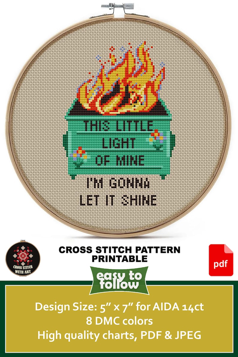 May include: Cross-stitch pattern featuring a green dumpster engulfed in flames, with the text "THIS LITTLE LIGHT OF MINE I'M GONNA LET IT SHINE." The design is in a wooden hoop. The design size is 5" x 7".