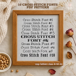 May include: A framed cross-stitch pattern with 10 different fonts. The fonts are labeled "Cross Stitch Font #1" through "Cross Stitch Font #10". The text "cap letters size: 8-10 sts" is at the bottom of the frame.