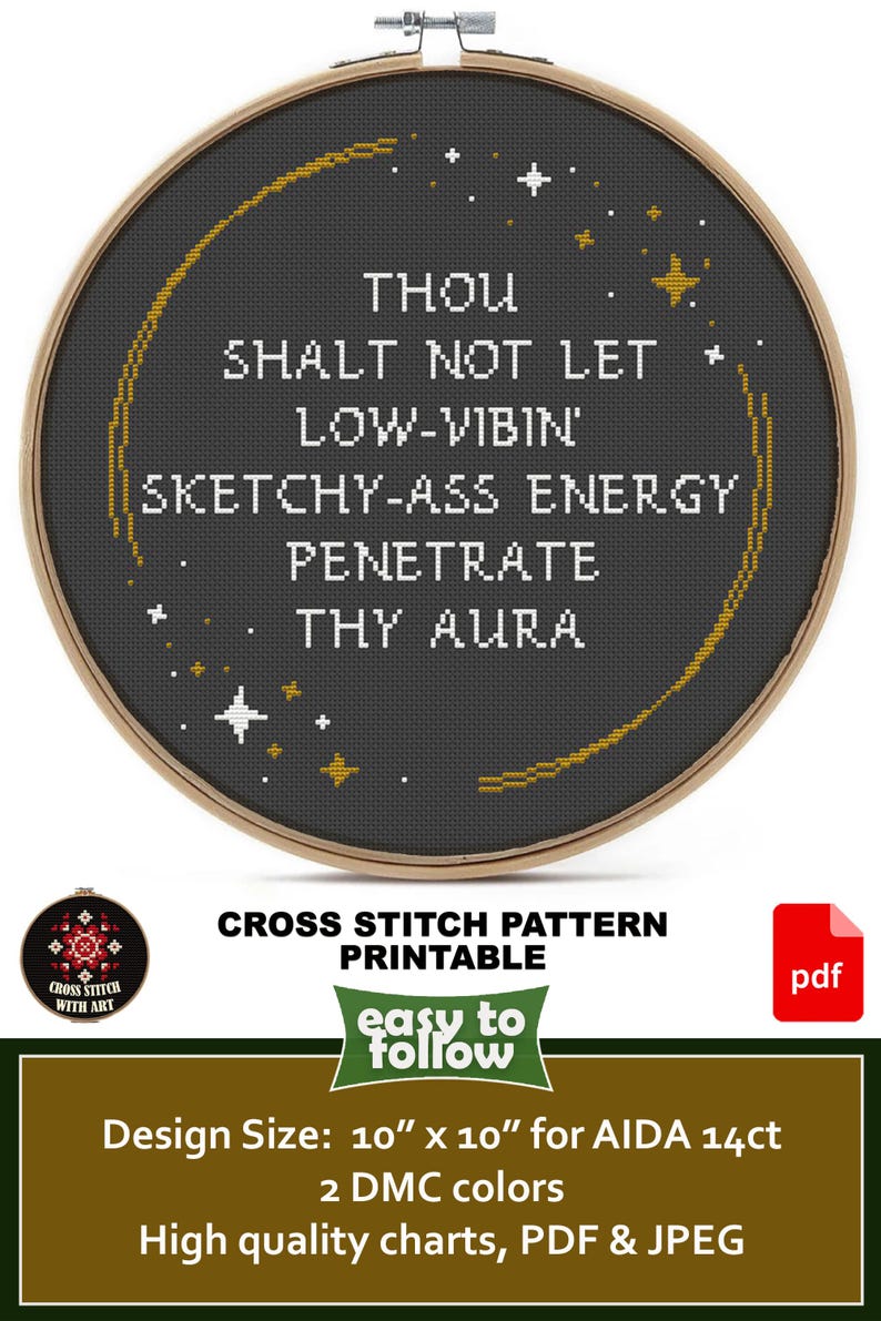May include: A circular wooden embroidery hoop containing a cross-stitch design on black fabric. The text reads: THOU SHALT NOT LET LOW-VIBIN' SKETCHY-ASS ENERGY PENETRATE THY AURA. The design features a gold crescent moon and small white and gold stars.