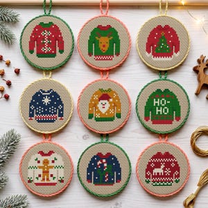 May include: Nine circular cross-stitch ornaments featuring pixelated holiday sweater designs. Each piece is framed in a colored rope border and displays motifs including a reindeer, Christmas tree, Santa Claus, gingerbread man, and the text HO-HO.