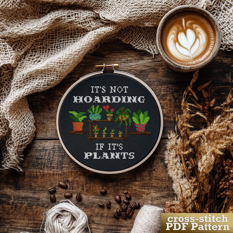 Cross stitch pattern PDF instant download for a 6-inch by 6 1/2-inch hoop. The pattern features a black background with white text that reads "It's not hoarding if it's plants." The design includes a shelf with potted plants in various colors.