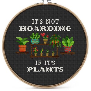 May include: A black embroidery hoop with the text "It's not hoarding if it's plants" and a colorful illustration of potted plants on a shelf.