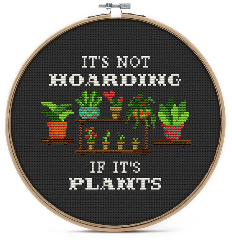 May include: A black embroidery hoop with the text "It's not hoarding if it's plants" and a colorful illustration of potted plants on a shelf.