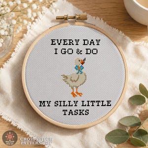 Funny goose cross stitch pattern PDF shown in a wooden hoop with the quote "Every Day I Go & Do My Silly Little Tasks" and complete design information.