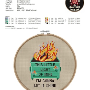 May include: Cross-stitch embroidery in a wooden hoop. The design features a green dumpster with flames and the text "THIS LITTLE LIGHT OF MINE I'M GONNA LET IT SHINE". The design area is 4.64" x 6.93".
