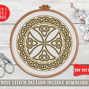 May include: A cross stitch pattern featuring a Celtic knot design in brown and gold colors. The pattern is displayed in a round embroidery hoop on a wooden surface. The text "PDF PATTERN" is visible in the lower right corner of the image.