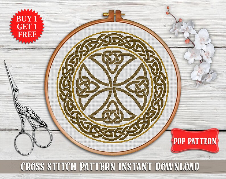 May include: A cross stitch pattern featuring a Celtic knot design in brown and gold colors. The pattern is displayed in a round embroidery hoop on a wooden surface. The text "PDF PATTERN" is visible in the lower right corner of the image.