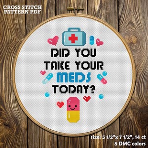 May include: Cross stitch pattern in a wooden hoop. The design features the text "DID YOU TAKE YOUR MEDS TODAY?" with a pill, hearts, and medical symbols. The pattern size is 5 1/2" x 7 1/2", 14 ct, and uses 8 DMC colors.