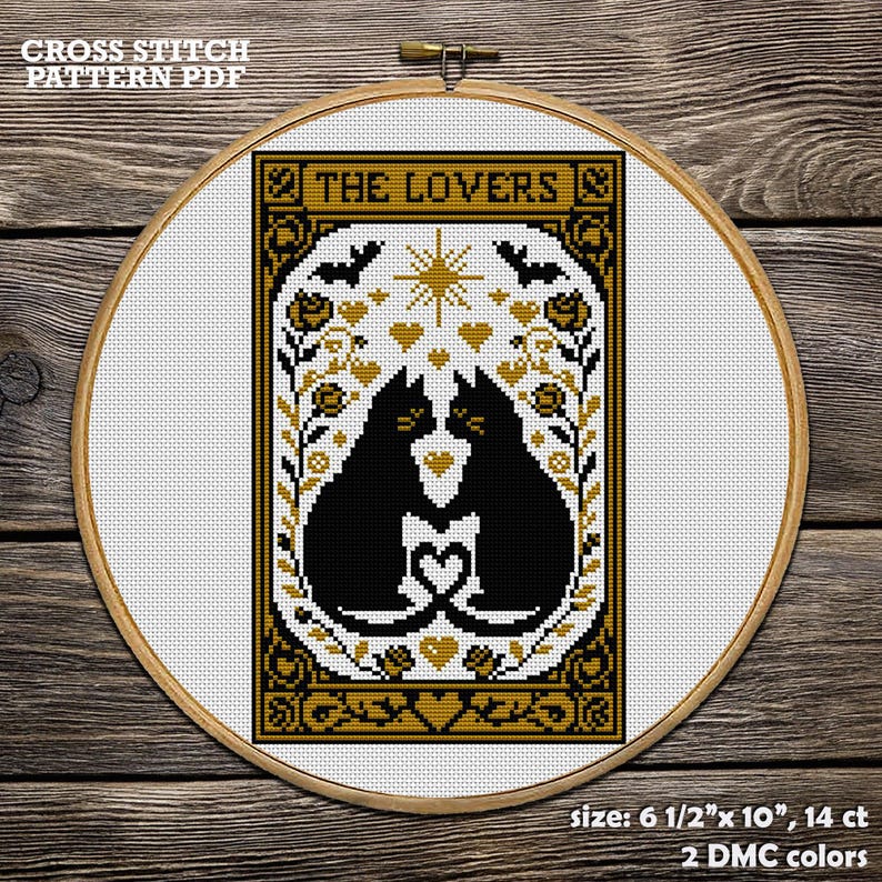 A cross-stitch PDF pattern featuring two black cats facing each other, forming a heart with their tails. The design includes bats, stars, and floral elements in gold and black.  Cat Cross Stitch Pattern PDF. The Lovers Gothic Tarot Embroidery Design. Funny Halloween Decor. Mystic Cat, Romantic Gift for Couples