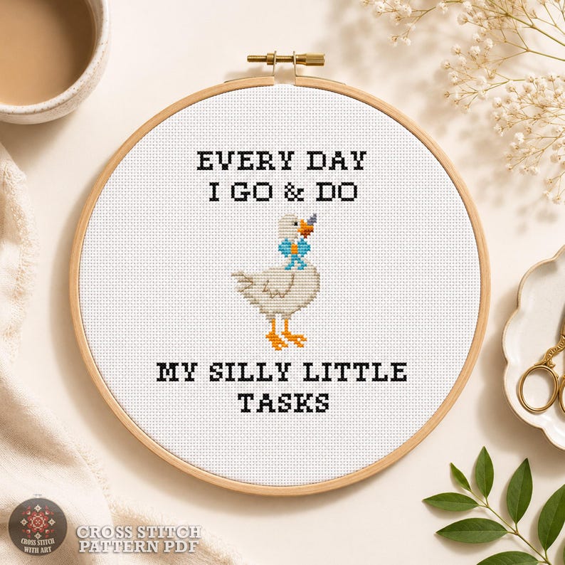 Funny goose cross stitch pattern PDF shown in a wooden hoop with the quote "Every Day I Go & Do My Silly Little Tasks" and complete design information.