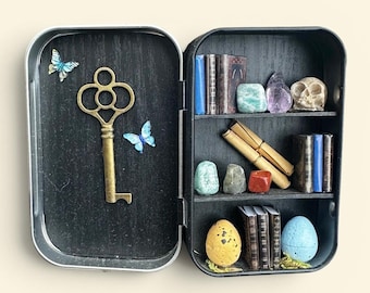 Miniature cabinet of curiosities with dragon skull and egg, parchments and real gemstones