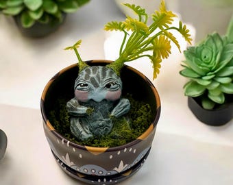 Babyblauwe Mandrake met onevenredige staartjes, gebeeldhouwd en met de hand beschilderd, in zijn metalen pot met groene mosvlokken