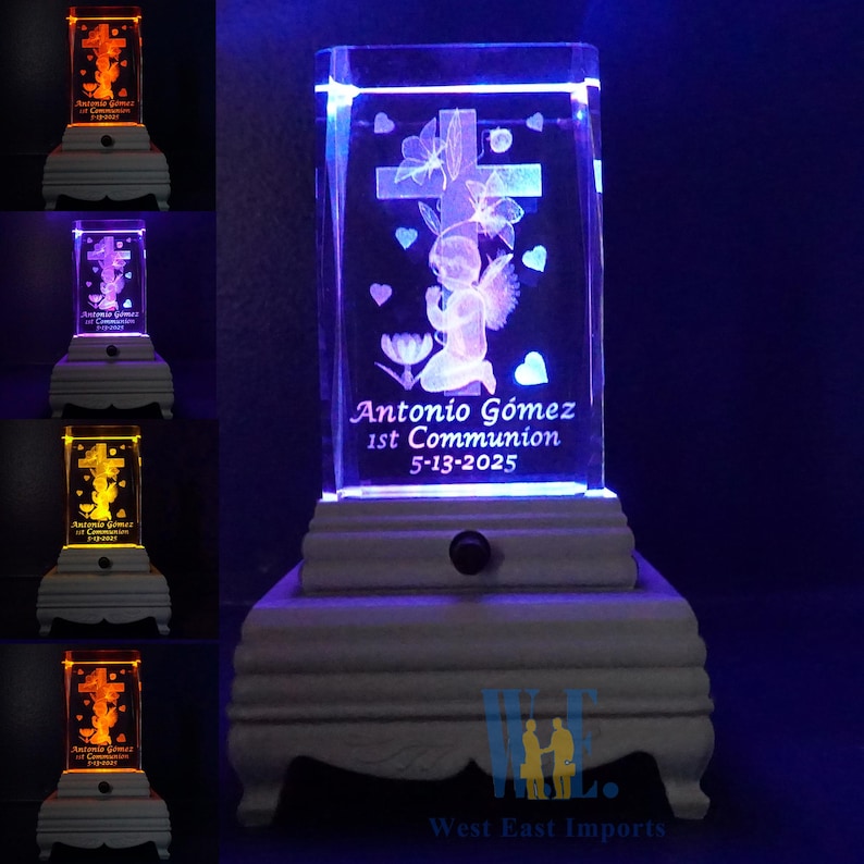 May include: A white wooden base with a clear crystal cube on top. The cube has a 3D laser engraved image of an angel kneeling in prayer with a cross behind it. The base has a light switch on the side and the words "Antonio Gomez 1st Communion 5-13-2025" are engraved on the crystal cube.