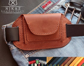 Peut inclure: Une pochette de ceinture en cuir marron clair avec un rabat et des coutures apparentes. L'image montre la pochette sur un jean bleu. L'image montre également des bobines de fil, des échantillons de cuir et le texte "NIKAZ Leather Craft".