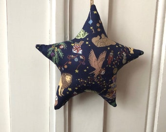 Padded star to hang in Liberty fabric Christmas patterns on navy blue backgrounds