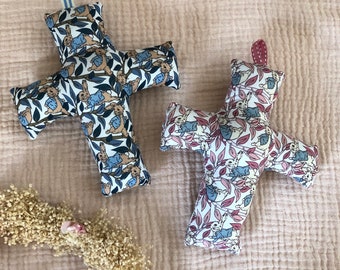 Padded cross in fabric with rabbit motifs in blue or pink tones