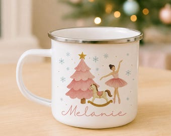 May include: A white enamel mug with a silver rim featuring a pink Christmas tree, a rocking horse, and a ballerina illustration. The name Melanie is printed in pink script below the graphics, surrounded by small blue snowflakes and gold dots.