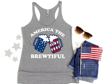 May include: A gray tank top with the text "America the Brewtiful" printed on it. The text is in white and there are two beer mugs with the American flag design on them.
