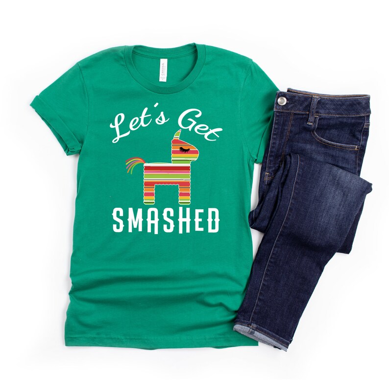 May include: A green t-shirt with a white graphic of a pinata and the text "Let's Get Smashed".